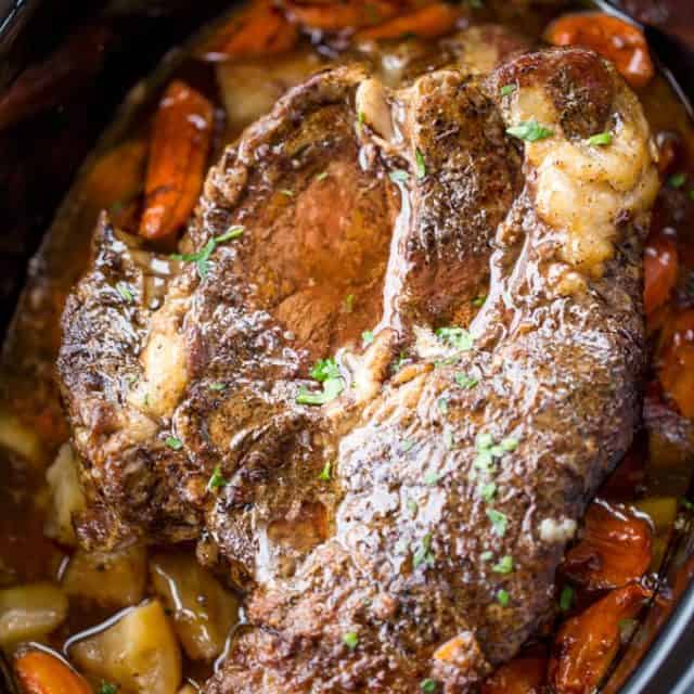 whole cooked roast with potatoes and carrots in crockpot