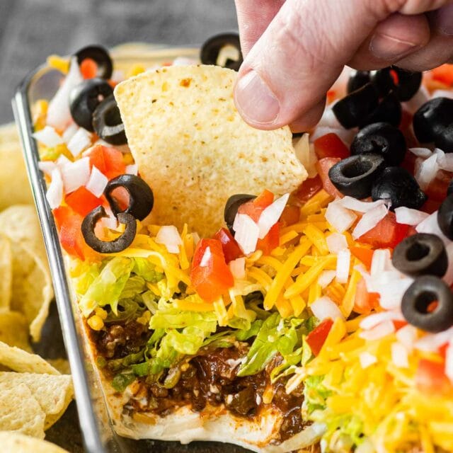Taco Dip in glass pan served with tortilla chips