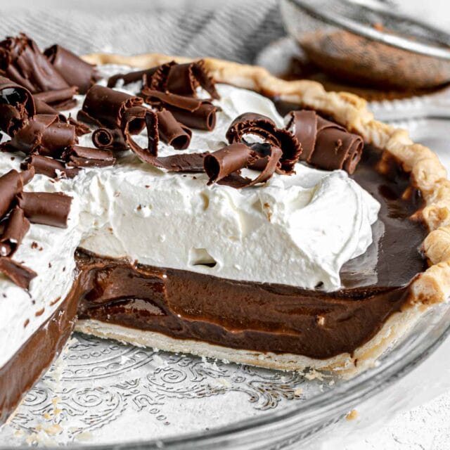 Chocolate Pie with whipped cream and chocolate shavings in pie dish