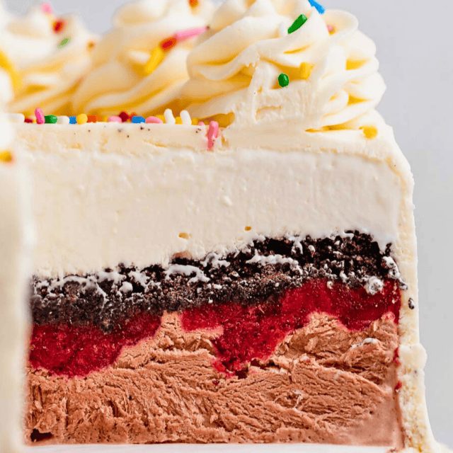 frozen rounded creamy dessert with a slice taken out of it on a platter