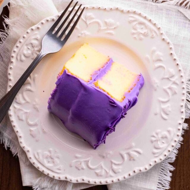 slice of double layer cake on plate with fork.