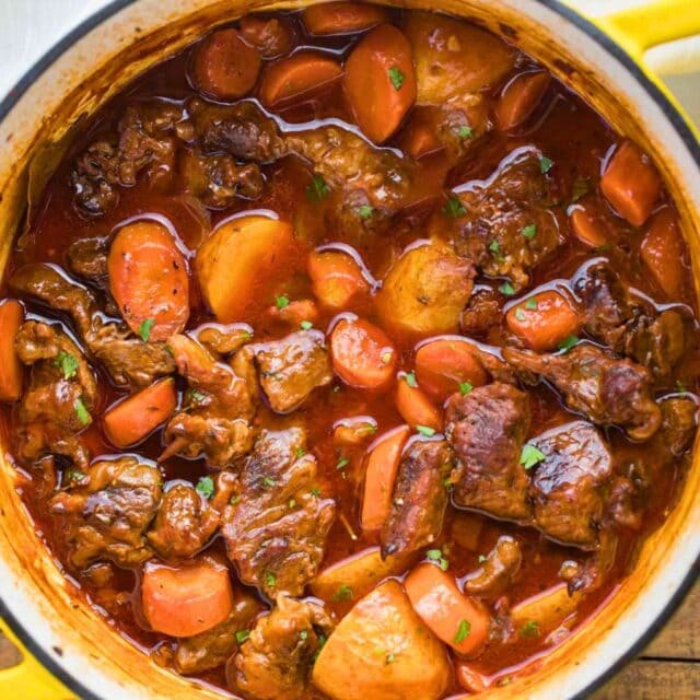 Top down view of stew in a yellow Dutch oven.
