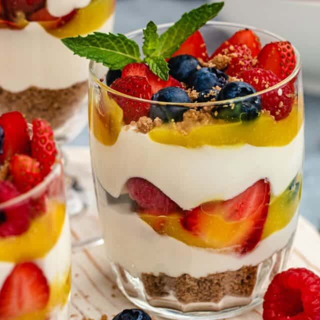 parfait showing the layers of cheesecake and berries.