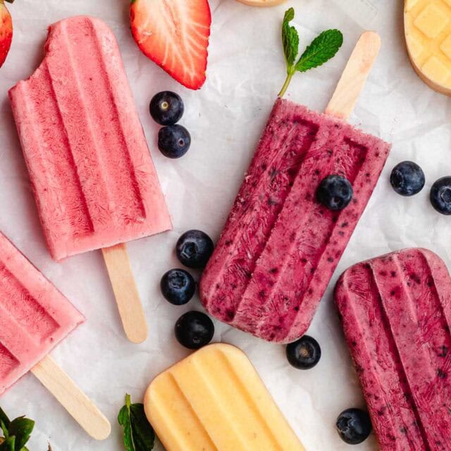 Homemade popsicles filled with mixed fruits.