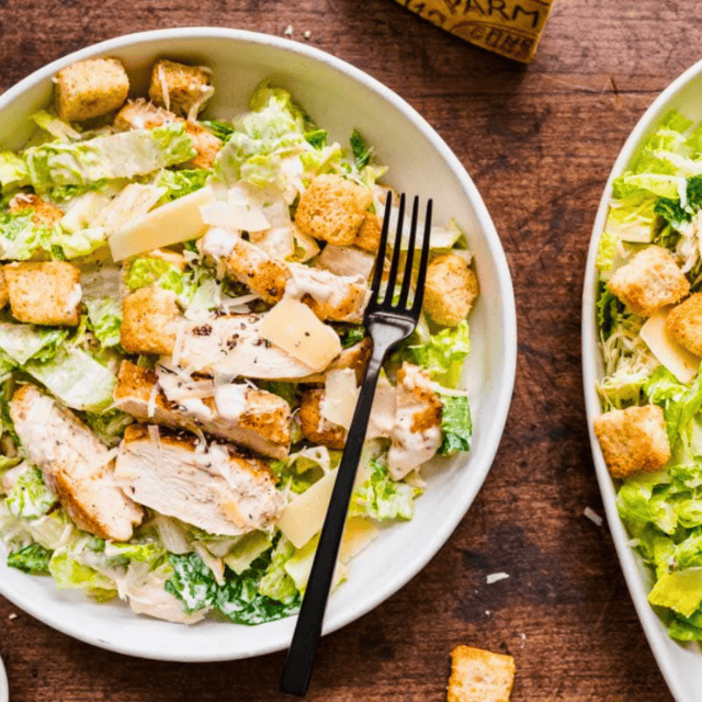 Bowl of salad next to platter of salad