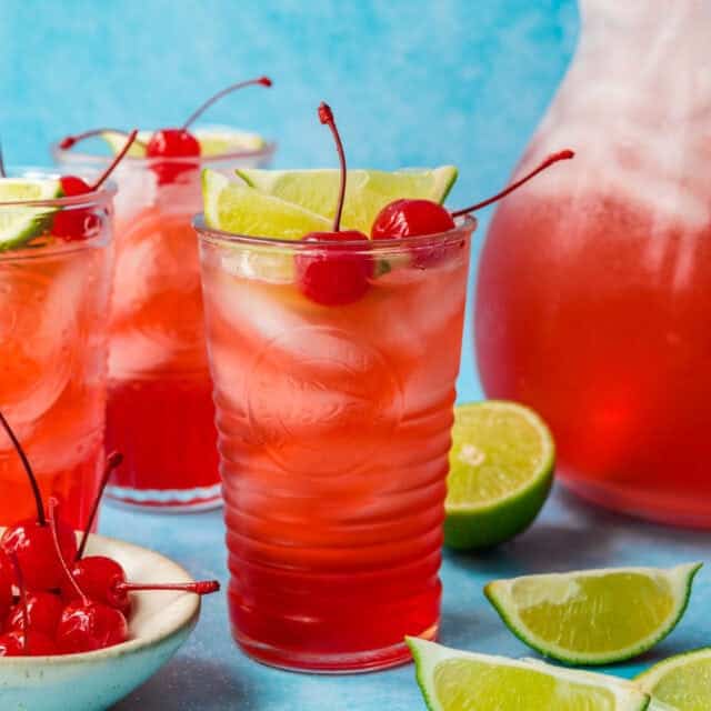 Pitcher and glasses filled with fruity beverage.